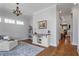 Inviting living area with hardwood floors, stylish lighting, and open layout leading to the kitchen at 7515 Cordery Rd, Cumming, GA 30040