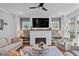 Cozy living room with a painted brick fireplace and a flat screen TV, flanked by built in shelves at 7515 Cordery Rd, Cumming, GA 30040