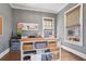Bright office space featuring a large desk, custom built-ins, and stylish decor at 7515 Cordery Rd, Cumming, GA 30040