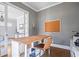 Charming office space with wood desk, built-in shelving, and ample natural light at 7515 Cordery Rd, Cumming, GA 30040