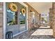 Inviting front porch with brick flooring and comfortable seating, creating a welcoming outdoor space at 7515 Cordery Rd, Cumming, GA 30040