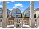 Inviting front porch with comfortable chairs and a charming view of the surrounding homes at 7515 Cordery Rd, Cumming, GA 30040