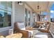 Spacious outdoor porch featuring stylish seating, a small table, and inviting views of the neighborhood at 7515 Cordery Rd, Cumming, GA 30040