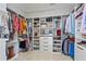 Organized walk-in closet with custom shelving and ample storage space for clothes and shoes at 7515 Cordery Rd, Cumming, GA 30040