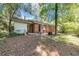 The exterior of the house shows a brick facade and a partially fenced backyard shaded by mature trees at 856 Glenway Dr, East Point, GA 30344