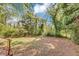 Spacious, shaded backyard featuring lush greenery and a partial fence, perfect for outdoor relaxation and entertainment at 856 Glenway Dr, East Point, GA 30344