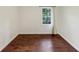 This bedroom features sleek wood-look flooring, a bright window, and a neutral color scheme at 856 Glenway Dr, East Point, GA 30344