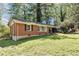 Quaint brick house surrounded by lush greenery and mature trees at 856 Glenway Dr, East Point, GA 30344