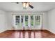 Bright, airy living room with hardwood floors, fan and large windows at 856 Glenway Dr, East Point, GA 30344