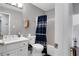 Bathroom featuring a white sink, toilet, tub with shower, and a blue patterned shower curtain at 1035 Avalon Dr, Lawrenceville, GA 30044