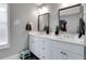 Bathroom with double sinks, white cabinets, and modern fixtures creating a clean and functional space at 1035 Avalon Dr, Lawrenceville, GA 30044