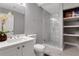 Modern bathroom featuring new vanity, toilet, tiled shower with glass door, and open shelves at 1035 Avalon Dr, Lawrenceville, GA 30044