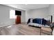 Well-lit bedroom with hardwood floors, TV, and large window offering plenty of natural light at 1035 Avalon Dr, Lawrenceville, GA 30044