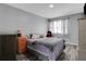 Cozy bedroom with neutral walls, grey floors, natural light, and comfy bedding at 1035 Avalon Dr, Lawrenceville, GA 30044