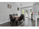 Sunlit dining area features a wooden table with six chairs, wood floors, and direct access to the backyard at 1035 Avalon Dr, Lawrenceville, GA 30044
