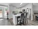 Open kitchen with white cabinets, stainless steel appliances, gray backsplash, and an island with bar stool seating at 1035 Avalon Dr, Lawrenceville, GA 30044