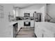 Bright kitchen featuring white cabinets, modern stainless steel appliances, and stylish backsplash, enhancing culinary space at 1035 Avalon Dr, Lawrenceville, GA 30044