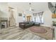 Spacious living room featuring hardwood floors, a ceiling fan, and a cozy seating area at 1035 Avalon Dr, Lawrenceville, GA 30044