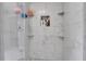 Modern shower with beautiful marble tiling, niche, and shelves for convenient storage of bath items at 1035 Avalon Dr, Lawrenceville, GA 30044