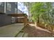 Spacious backyard with a patio, pergola, and mature trees along the fenced perimeter at 4111 Mcever Woods Nw Dr, Acworth, GA 30101