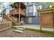 A view of a two-story deck and a fenced yard with a stone patio at 4111 Mcever Woods Nw Dr, Acworth, GA 30101