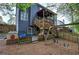 Spacious backyard featuring a wood deck, swing set, and playhouse, perfect for outdoor fun at 4111 Mcever Woods Nw Dr, Acworth, GA 30101