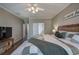 The main bedroom boasts neutral decor, ceiling fan and wood-look flooring at 4111 Mcever Woods Nw Dr, Acworth, GA 30101