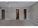 Large bedroom with neutral walls, plush carpeting, and multiple doorways at 4111 Mcever Woods Nw Dr, Acworth, GA 30101