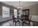 Formal dining room featuring elegant furnishings, wainscoting, and large windows for natural light at 4111 Mcever Woods Nw Dr, Acworth, GA 30101