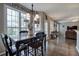 Dining room with lots of windows with wooded views, a dark wood table, and a modern chandelier at 4111 Mcever Woods Nw Dr, Acworth, GA 30101