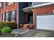 Close-up of the home's entrance showing the front door, garage, and manicured landscaping at 4111 Mcever Woods Nw Dr, Acworth, GA 30101