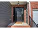 The front door features sidelights and transom windows, with a 'welcome' mat and elegant hardware at 4111 Mcever Woods Nw Dr, Acworth, GA 30101