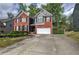 Beautifully landscaped front yard and long driveway leading up to a two-story brick and gray home at 4111 Mcever Woods Nw Dr, Acworth, GA 30101