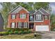 Charming two-story brick home with a manicured lawn and a two-car garage in a desirable neighborhood at 4111 Mcever Woods Nw Dr, Acworth, GA 30101