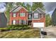 Charming two-story brick home with a manicured lawn and a two-car garage in a desirable neighborhood at 4111 Mcever Woods Nw Dr, Acworth, GA 30101