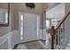 Bright foyer with decorative wainscoting, wood floors, leading to a dining room and the main entrance at 4111 Mcever Woods Nw Dr, Acworth, GA 30101
