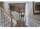 View of foyer with wood floors, carpeted stairs, and decorative molding; a view to other rooms beyond at 4111 Mcever Woods Nw Dr, Acworth, GA 30101
