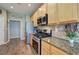 The kitchen features granite countertops, stainless steel appliances, beautiful cabinetry and wood-look floors at 4111 Mcever Woods Nw Dr, Acworth, GA 30101