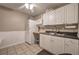 Bright kitchen with white cabinetry, stainless steel sink, and a microwave, bathed in natural light at 4111 Mcever Woods Nw Dr, Acworth, GA 30101