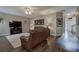 Open-concept living room with hardwood floors, a large TV, and access to the foyer at 4111 Mcever Woods Nw Dr, Acworth, GA 30101