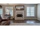 Inviting living room with fireplace, two large windows, and hardwood flooring at 4111 Mcever Woods Nw Dr, Acworth, GA 30101