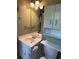 This bathroom features a white vanity, a large mirror, cabinet storage, and neutral-colored walls at 4152 Scenic Mountain Dr, Snellville, GA 30039