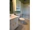 Bright bathroom featuring a tiled shower-tub combo, white vanity, and white hexagon tiled flooring at 4152 Scenic Mountain Dr, Snellville, GA 30039