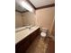 Traditional bathroom with a long vanity, a toilet, a large mirror, and textured walls at 4152 Scenic Mountain Dr, Snellville, GA 30039