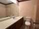 Simple bathroom featuring a vanity with drawers, a toilet, a large mirror, and a shower-tub combo at 4152 Scenic Mountain Dr, Snellville, GA 30039