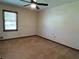 Bright carpeted bedroom with neutral paint, ceiling fan, and a large window for ample natural light at 4152 Scenic Mountain Dr, Snellville, GA 30039