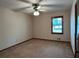 A cozy bedroom with neutral carpet, a ceiling fan, and a window offering natural light at 4152 Scenic Mountain Dr, Snellville, GA 30039