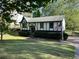 Charming Tudor-style home featuring an American flag and meticulous landscaping at 4152 Scenic Mountain Dr, Snellville, GA 30039