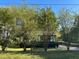 Charming home with mature trees and landscaping, featuring an American flag at 4152 Scenic Mountain Dr, Snellville, GA 30039