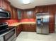 Traditional kitchen features stainless steel appliances and wood cabinetry at 4152 Scenic Mountain Dr, Snellville, GA 30039